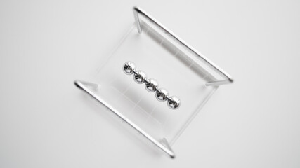 a diamond shaped top view of cradle steel balance balls.