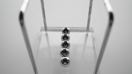 a close up of cradle steel balance ball.