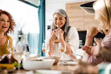 Adult woman very happy with a gift from friends