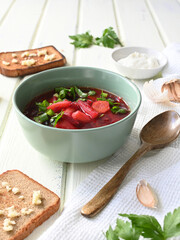 Traditional Ukrainian Russian vegetable soup, borsch with garlic donuts and bread