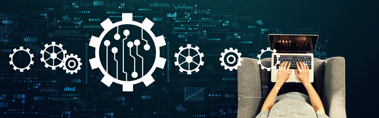 Obraz premium Automation concept with person using a laptop in a chair