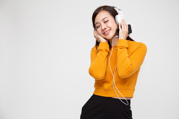 Young Asian beauty woman listening music with headphones in playlist song application on smartphone isolated on white background