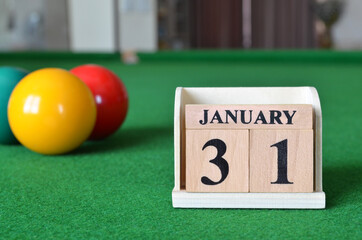Janaury 31, number cube with balls on snooker table, sport background.