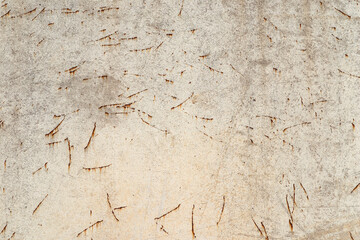 A seamless detailed background made of a gray concrete wall with cuts and a rust bloom.
