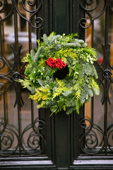 Fototapeta na wymiar Beautiful Christmas wreath on the old wooden door