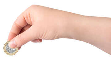 A female hand holding a one pound British coin on white background, isolated.
