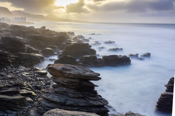 Long exposure shot of sunset on a rocky coast 
