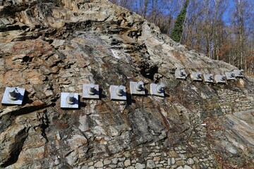 Bolts in a rock face to stabilise and tension the slope beside the road in Gwynedd, Wales.