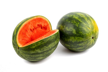 two green round seedless watermelons one whole and one cut up isolated on a white background