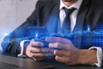 Businessman trading stocks using on-line app on phone. Financial graph hologram.