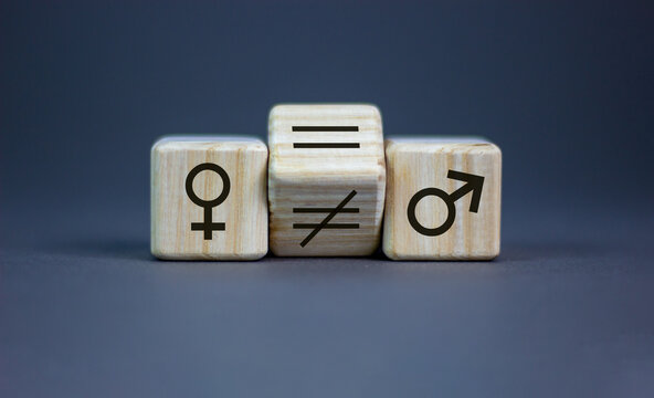 Symbol for gender equality. Turned a cube and changed a unequal sign to a equal sign between symbols of men and women. Beautiful grey background, copy space.