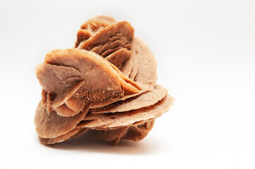 A very popular souvenir among tourists - an unusual mineral called - desert rose on a light...
