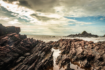 natural rock formation at sea shore due to crashing waves at morning