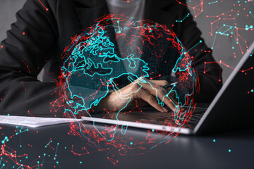 Businesswoman typing on laptop in office. Planet earth world map hologram. International business concept. Double exposure.