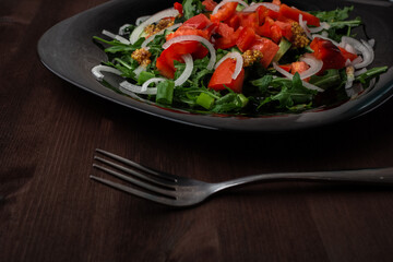 pepper cucumber and onion salad seasoned with mustard on a plate on a wooden table