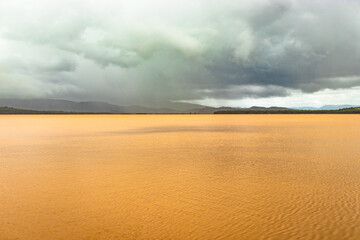 pristine landscape with lake calm water and dramatic sky at morning from flat angle