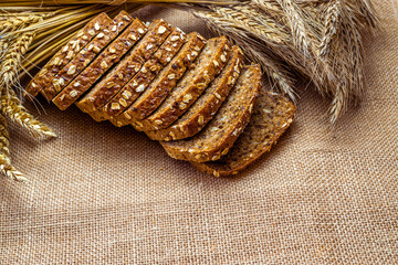 Freshly baked bread. Fresh loaf of rustic traditional bread with wheat grain ear or spike plant on...