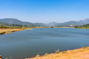 Awesome view of small lake  near a greenery mountain background.
