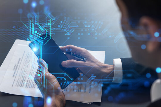 Businessman in office working with Smartphone, new technologies hologram to optimize the process, typing phone. Double exposure.