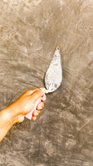 Tiler's hand.bricklayer plaster a wall inside a building
