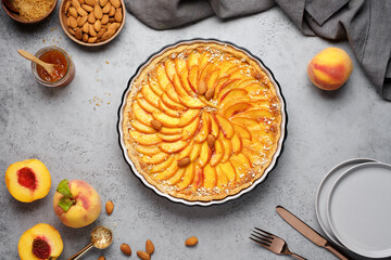 Peach tart with almonds. Homemade dessert. Top view, food concrete background