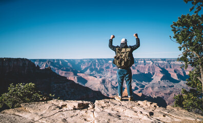 Male hiker with raised hands in Grand Canyon