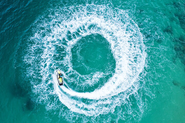 People are playing a jet ski in the sea.Aerial view. Top view.amazing nature background. The color of the water and beautifully bright.