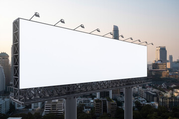 Blank white road billboard with Bangkok cityscape background at sunset. Street advertising poster, mock up, 3D rendering. Side view. The concept of marketing communication to promote or sell idea.