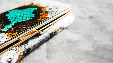 lock on the wallet is made of eco-friendly artificial texture of snakeskin close-up.