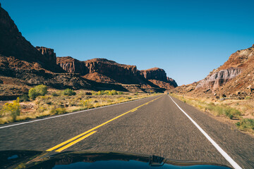 Car driving through dry rocky terrain in USA