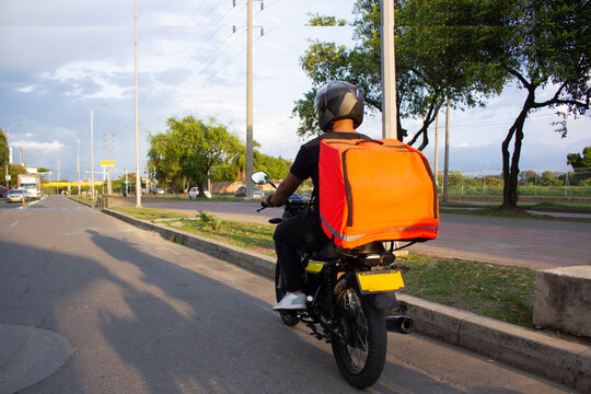 behing fast food delivery man on the road