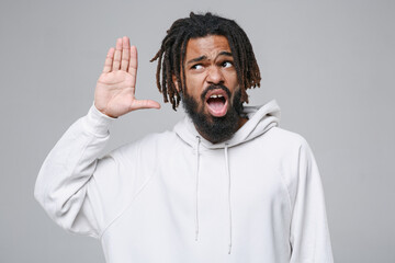 Shocked curious young african american man with dreadlocks 20s in white casual streetwear hoodie...