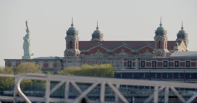 Low angle, Statue of Liberty behind Ellis Island