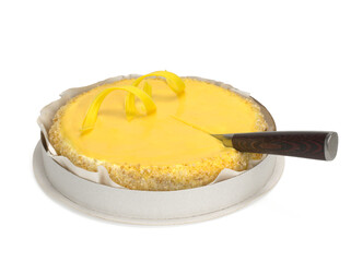 Sponge cake with cream, lemon cream and a knife in it on a white background.