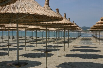 Empty beach with umbrellas. The photo is taken in Durres beach in Albania outside the tourist season.