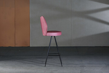 High modern chair with long legs and purple soft upholstery