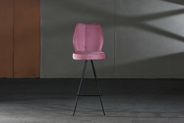 High modern chair with long legs and purple soft upholstery