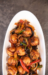 .fried dumplings in a white plate on a concrete background