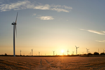 Wind turbines at sunrise. Landscape at sunrise with windmills.