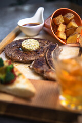 .whiskey and steak with sauce on wood
