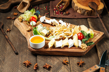 Wine appetizers with cheese on the wooden board 