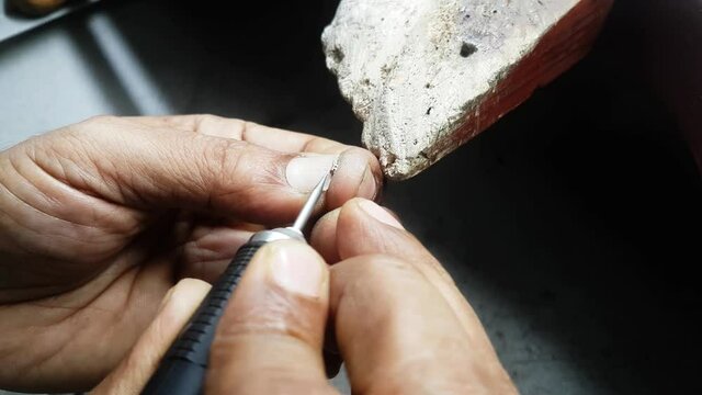 Making of Diamond Tennis Bracelet Gold Colette Finishing work Given by Goldsmith Hand on the wooden Table