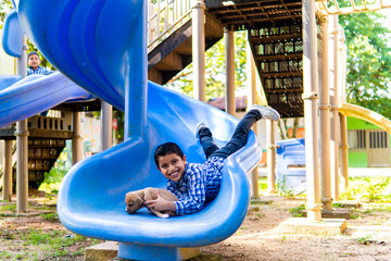 Fototapeta na wymiar 8 to 13 year old boy playing in a public park