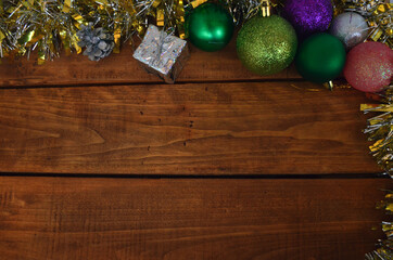 New Year's layout on a wooden background. Christmas decorations for the tree, balls, gifts.
