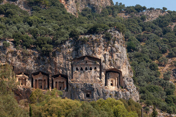 Fototapeta na wymiar Lycian Royal mountain tombs carved into the rocks near the town of Dalyan in the province of Marmaris in Turkey