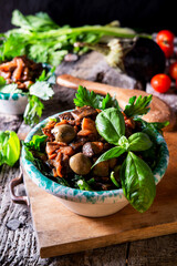 vertical photo of a eggplant caponata, typical Sicilian salad