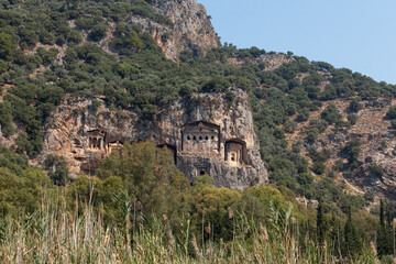 Fototapeta premium Lycian Royal mountain tombs carved into the rocks near the town of Dalyan in the province of Marmaris in Turkey