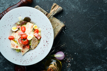 Caesar salad with chicken in a plate. Vegetable salad. Top view. Free copy space.