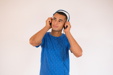 Happy young man with headphones. Listening music