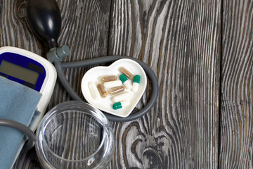 Tonometer and a handful of pills. To control blood pressure. Diagnostics and treatment of cardiovascular diseases.